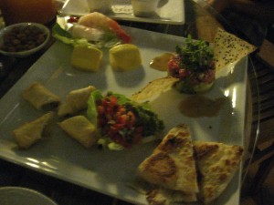 From top left: shrimp cocktail, tuna tartare, chicken quesadilla and vegetable spring roll